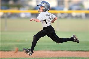 Young baseball player running to base